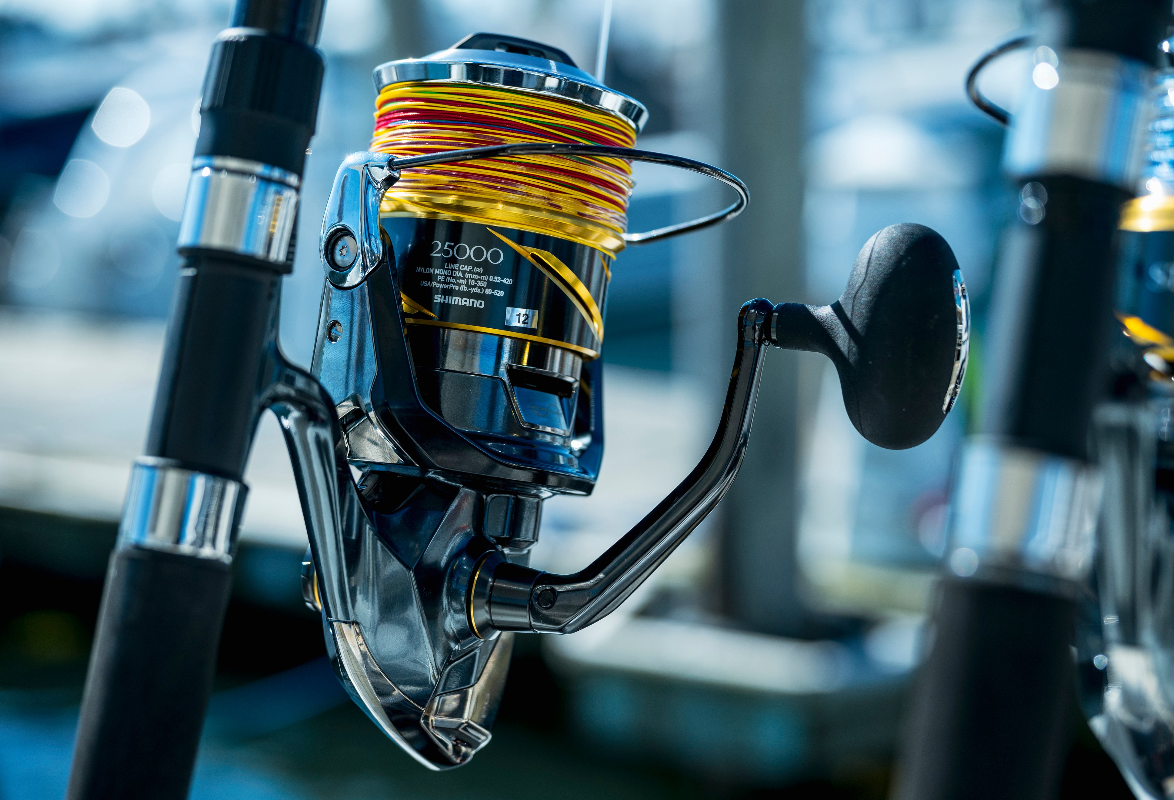 Close-up of a Shimano spinning reel spooled with braided fishing line mounted on a fishing rod.